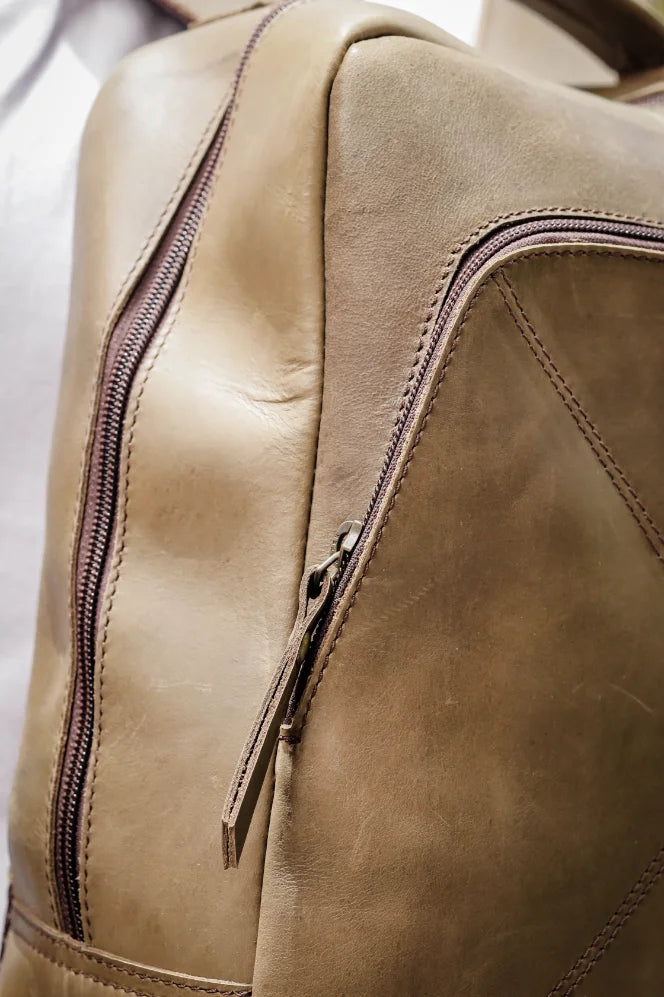 close up shot of beige leather backpack